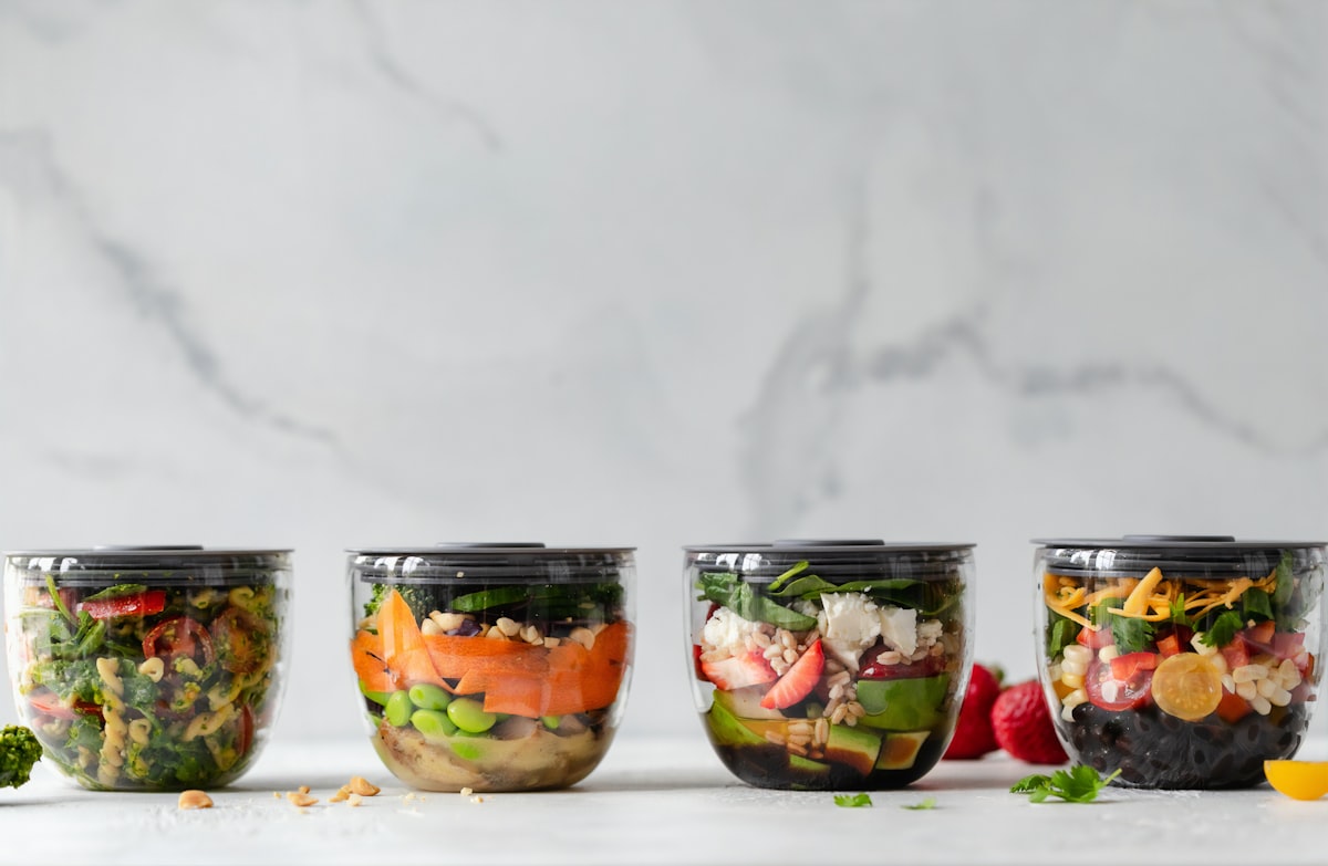 Woman preparing healthy meal with fresh vegetables and whole grains